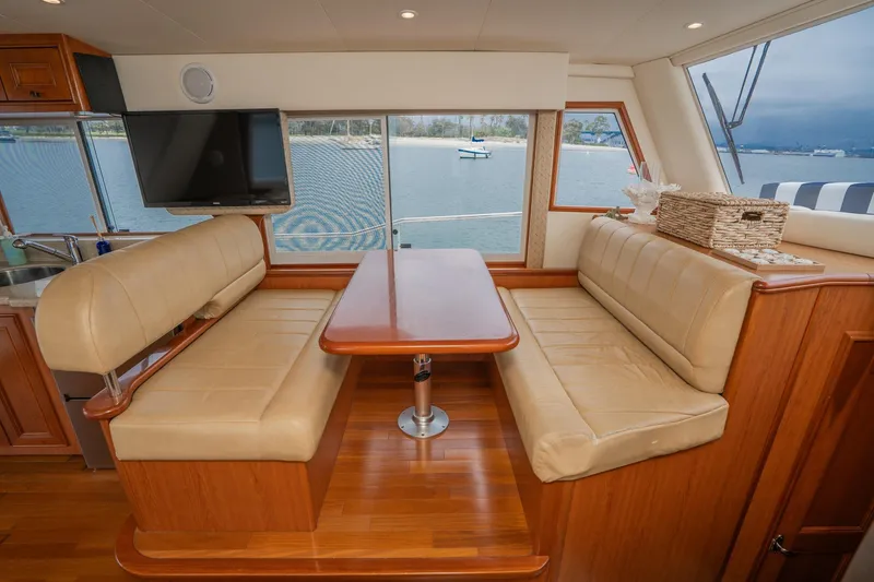 Slide: The Image of Interior of 2011 Mainship 395 Trawler with dining area and scenic window view. - 54