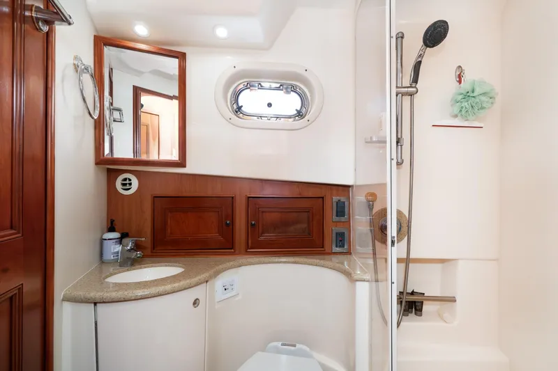 Slide: The Image of Bathroom interior of 2011 Mainship 395 Trawler with shower and wooden cabinetry. - 59