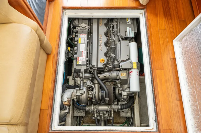 Slide: The Image of Engine compartment of a 2011 Mainship 395 Trawler, showcasing detailed mechanical components. - 60