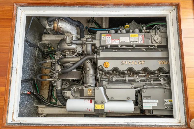 Slide: The Image of Engine compartment of a 2011 Mainship 395 Trawler, featuring a 24-valve Yanmar engine. - 61