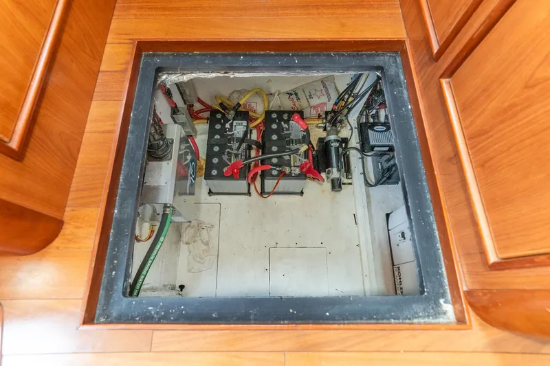 Slide: The Image of Engine compartment of 2011 Mainship 395 Trawler with visible batteries and wiring. - 62