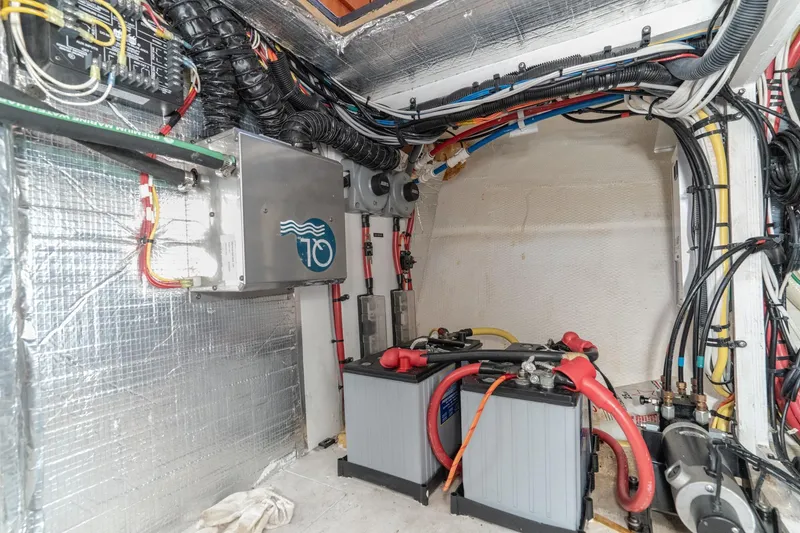 Slide: The Image of Engine room of 2011 Mainship 395 Trawler with wiring and battery setup. - 64