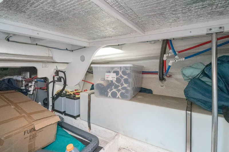 Slide: The Image of Interior storage area of a 2011 Mainship 395 Trawler with organized equipment and supplies. - 65