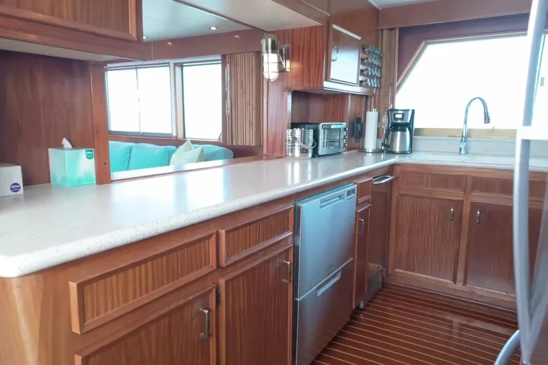 Slide: The Image of Interior of 1980 Hatteras 70 Motor Yacht kitchen with wood cabinetry and modern appliances. - 10
