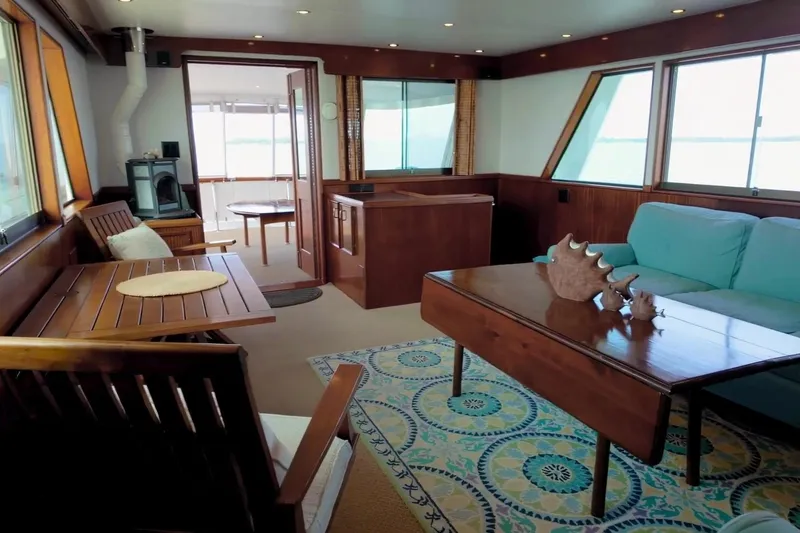 Slide: The Image of Interior of 1980 Hatteras 70 Motor Yacht with wooden furniture and sea view. - 12