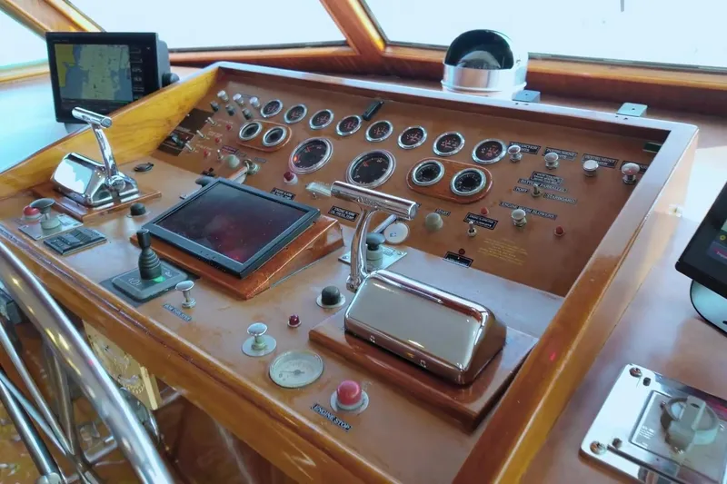 Slide: The Image of Control panel of a 1980 Hatteras 70 Motor Yacht with gauges and navigation equipment. - 5