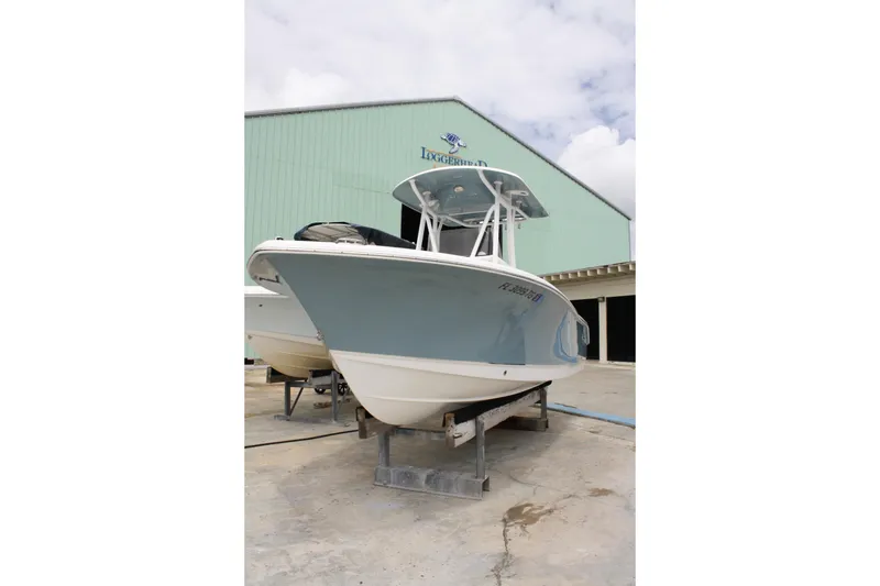 Slide: The Image of 2022 Sea Hunt Ultra 219 boat on display outside a marine facility. - 10