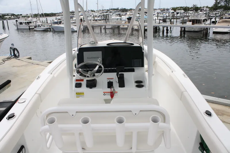 Slide: The Image of 2022 Sea Hunt Ultra 219 boat interior with Garmin navigation, docked at marina. - 11