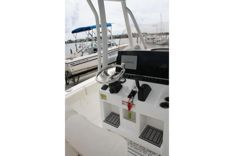 Slide: The Image of 2022 Sea Hunt Ultra 219 boat console with steering wheel and Garmin navigation system. - 12