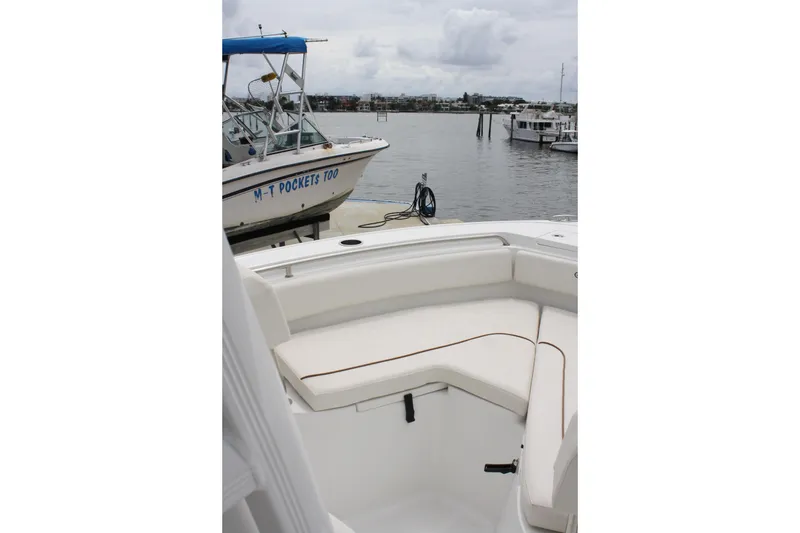 Slide: The Image of 2022 Sea Hunt Ultra 219 boat interior with docked boats in the background. - 14