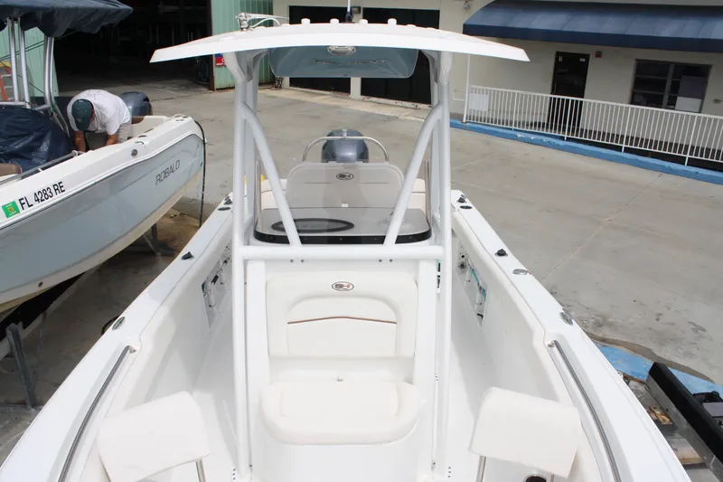 Slide: The Image of 2022 Sea Hunt Ultra 219 boat docked, featuring spacious seating and modern design. - 17