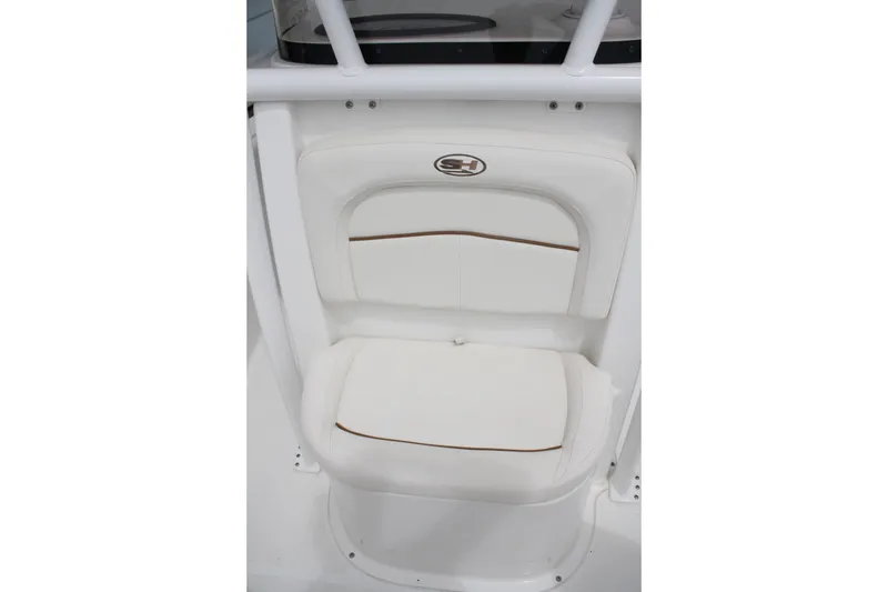 Slide: The Image of 2022 Sea Hunt Ultra 219 boat seat with white cushioned design and logo detail. - 19