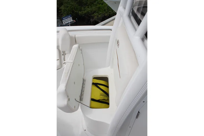 Slide: The Image of 2022 Sea Hunt Ultra 219 boat seat with storage compartment open. - 20