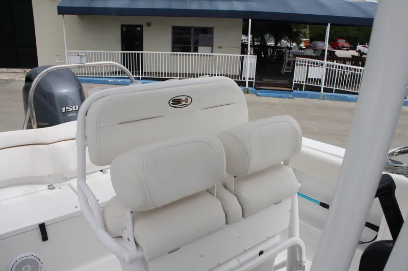 Slide: The Image of 2022 Sea Hunt Ultra 219 boat with white seating and Yamaha 150 engine. - 23