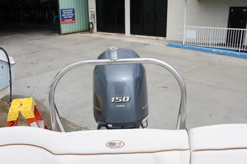 Slide: The Image of 2022 Sea Hunt Ultra 219 with Yamaha 150 engine at a dockside location. - 25