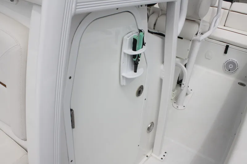 Slide: The Image of 2022 Sea Hunt Ultra 219 boat interior with storage compartment and seating. - 27
