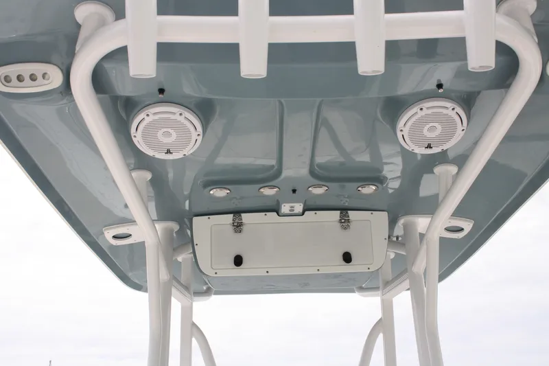 Slide: The Image of 2022 Sea Hunt Ultra 219 boat T-top with speakers and rod holders. - 29