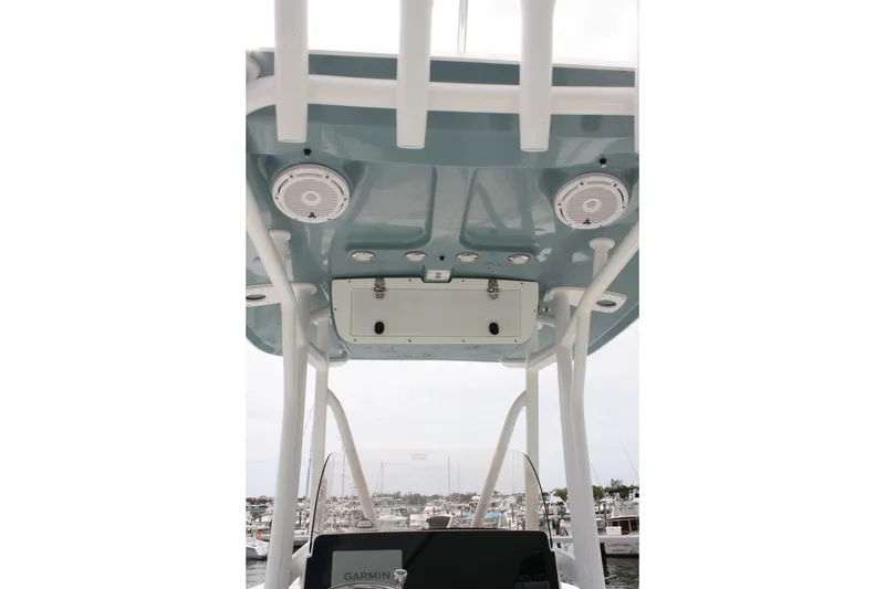 Slide: The Image of T-top view of 2022 Sea Hunt Ultra 219 boat with speakers and storage. - 30