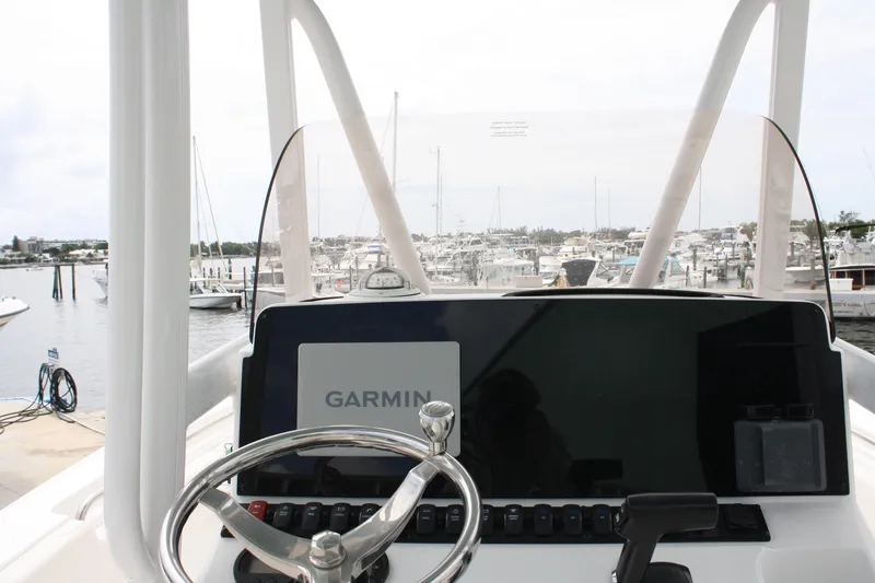 Slide: The Image of 2022 Sea Hunt Ultra 219 boat dashboard with Garmin navigation system at marina. - 31