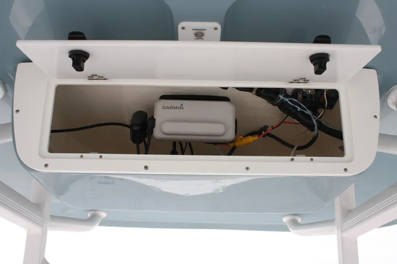 Slide: The Image of 2022 Sea Hunt Ultra 219 boat electronics compartment with Garmin device and wiring. - 32