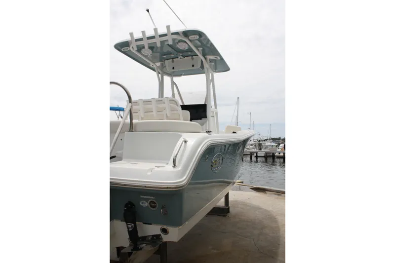 Slide: The Image of 2022 Sea Hunt Ultra 219 boat docked at marina, showcasing sleek design and modern features. - 8