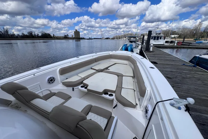 Slide: The Image of 2020 Everglades 365 Center Console boat docked, featuring spacious seating and scenic waterfront view. - 3