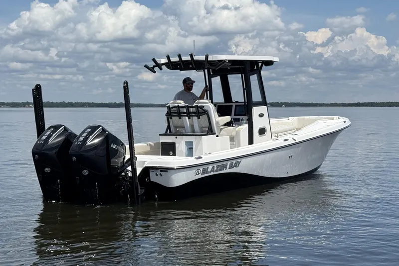 Slide: The Image of 2026 Blazer Bay Makaira 2800 boat on calm water under a cloudy sky. - 1