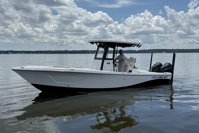 Slide: The Image of 2026 Blazer Bay Makaira 2800 boat on calm water under cloudy sky. - 3