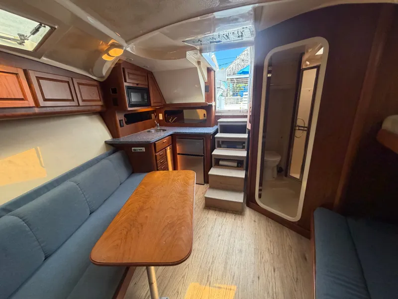Slide: The Image of Interior of a 1998 Luhrs Open yacht with kitchen and seating area. - 12