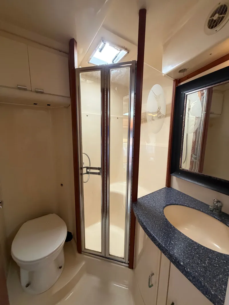 Slide: The Image of 1998 Luhrs Open yacht bathroom with shower and toilet. - 13