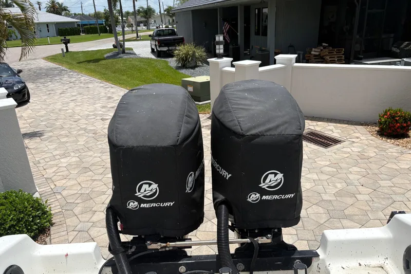 Slide: The Image of Twin Mercury outboard motors on a 2001 Fountain 31 Center Console boat. - 11