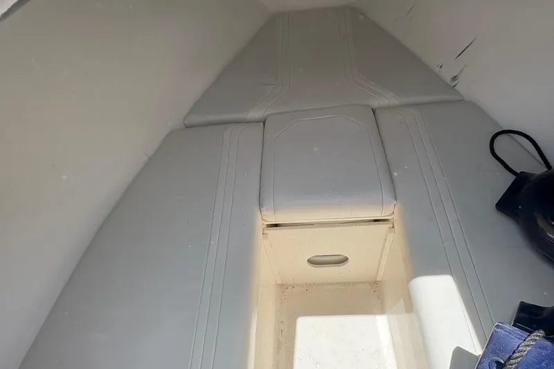 Slide: The Image of Interior of a 2001 Fountain 31 Center Console boat, featuring cushioned seating and storage. - 13