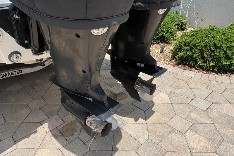 Slide: The Image of Outboard motors of a 2001 Fountain 31 Center Console boat on a paved surface. - 14