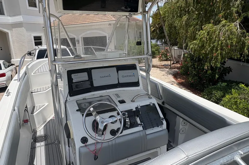Slide: The Image of 2001 Fountain 31 Center Console boat with Garmin navigation, parked near a house. - 5