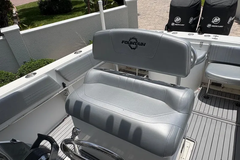 Slide: The Image of 2001 Fountain 31 Center Console boat interior with gray seating and Mercury engines. - 6