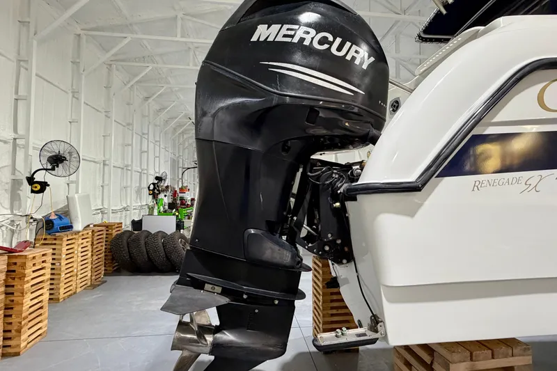 Slide: The Image of 2006 Glacier Bay 2640SX Renegade boat with Mercury outboard motor in a storage facility. - 12