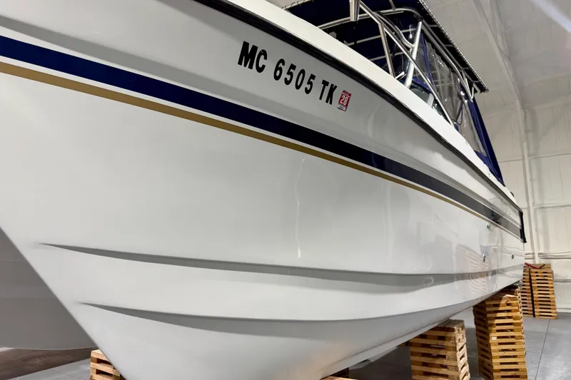 Slide: The Image of 2006 Glacier Bay 2640SX Renegade boat on wooden blocks in a storage facility. - 15