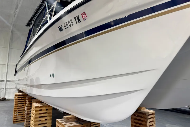Slide: The Image of 2006 Glacier Bay 2640SX Renegade boat on wooden blocks in a storage facility. - 16