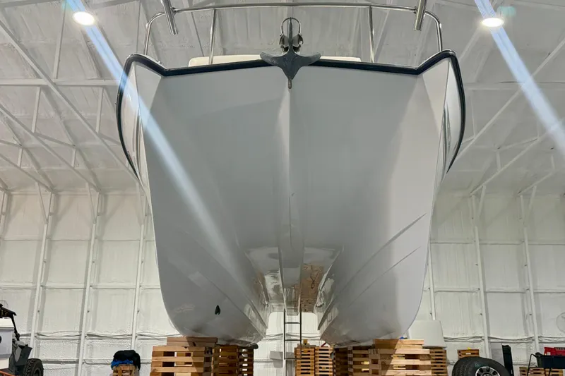 Slide: The Image of 2006 Glacier Bay 2640SX Renegade boat in indoor storage, viewed from the front. - 17