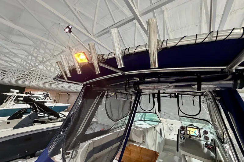 Slide: The Image of 2006 Glacier Bay 2640SX Renegade boat interior with rod holders and navigation equipment. - 19