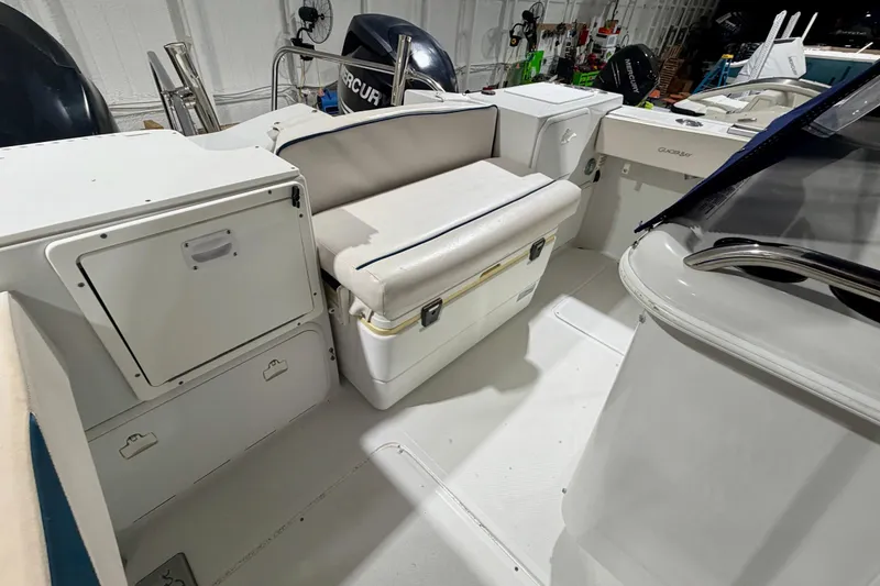 Slide: The Image of 2006 Glacier Bay 2640SX Renegade boat interior with seating and storage compartments. - 25