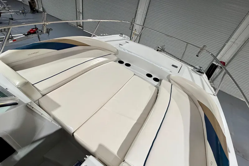 Slide: The Image of 2006 Glacier Bay 2640SX Renegade boat interior with cushioned seating and railings. - 27