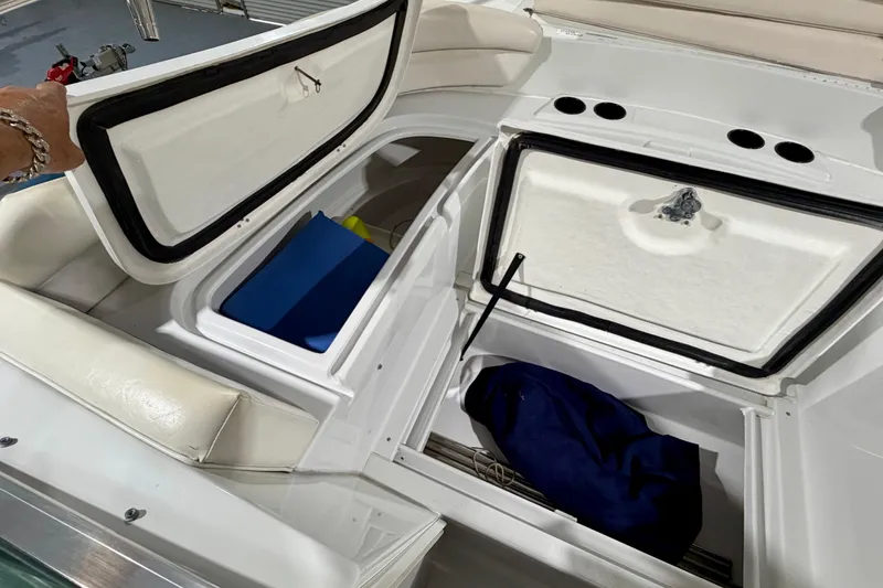 Slide: The Image of 2006 Glacier Bay 2640SX Renegade boat storage compartments with open hatches and visible gear. - 29