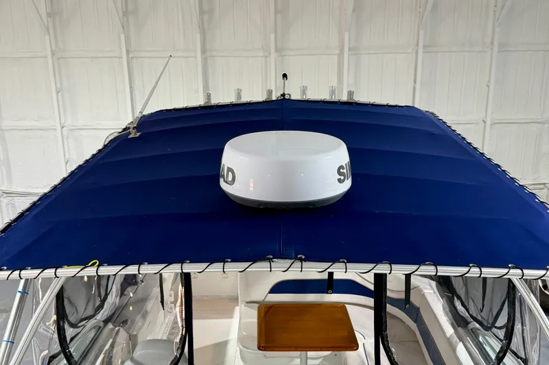 Slide: The Image of 2006 Glacier Bay 2640SX Renegade boat with blue canopy and radar dome. - 30