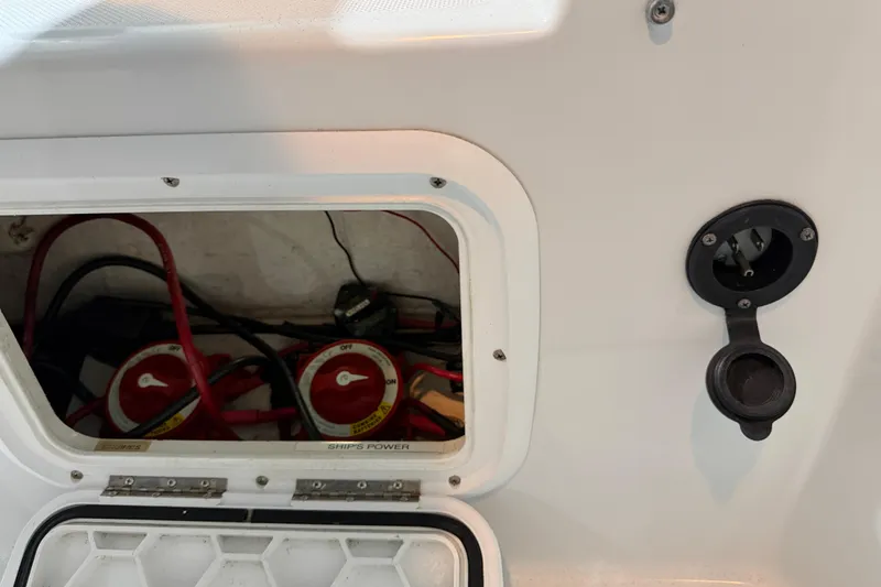 Slide: The Image of Battery compartment of 2006 Glacier Bay 2640SX Renegade boat, showing wiring and switches. - 33