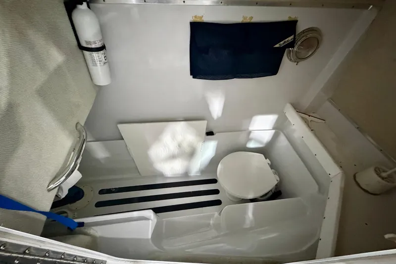 Slide: The Image of 2006 Glacier Bay 2640SX Renegade boat interior with toilet and fire extinguisher. - 35