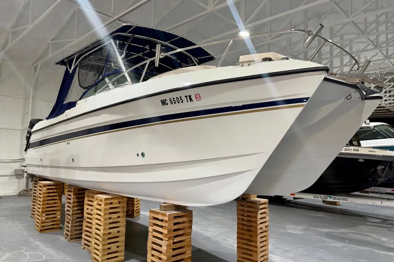 Slide: The Image of 2006 Glacier Bay 2640SX Renegade boat in storage, elevated on wooden blocks. - 5