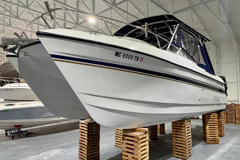 Slide: The Image of 2006 Glacier Bay 2640SX Renegade boat in indoor storage on wooden blocks. - 6
