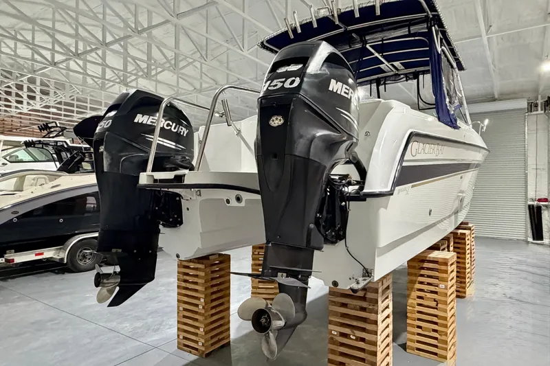 Slide: The Image of 2006 Glacier Bay 2640SX Renegade boat with twin Mercury engines in a storage facility. - 8