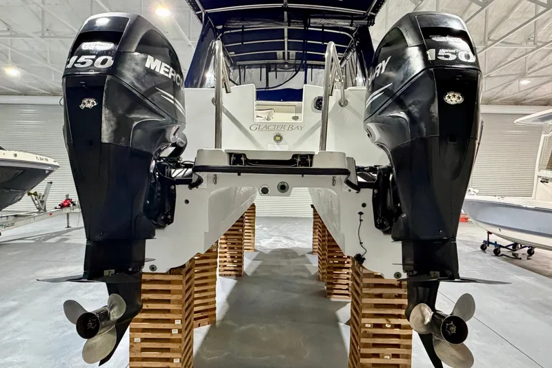 Slide: The Image of 2006 Glacier Bay 2640SX Renegade with twin Mercury 150 engines in a showroom. - 9